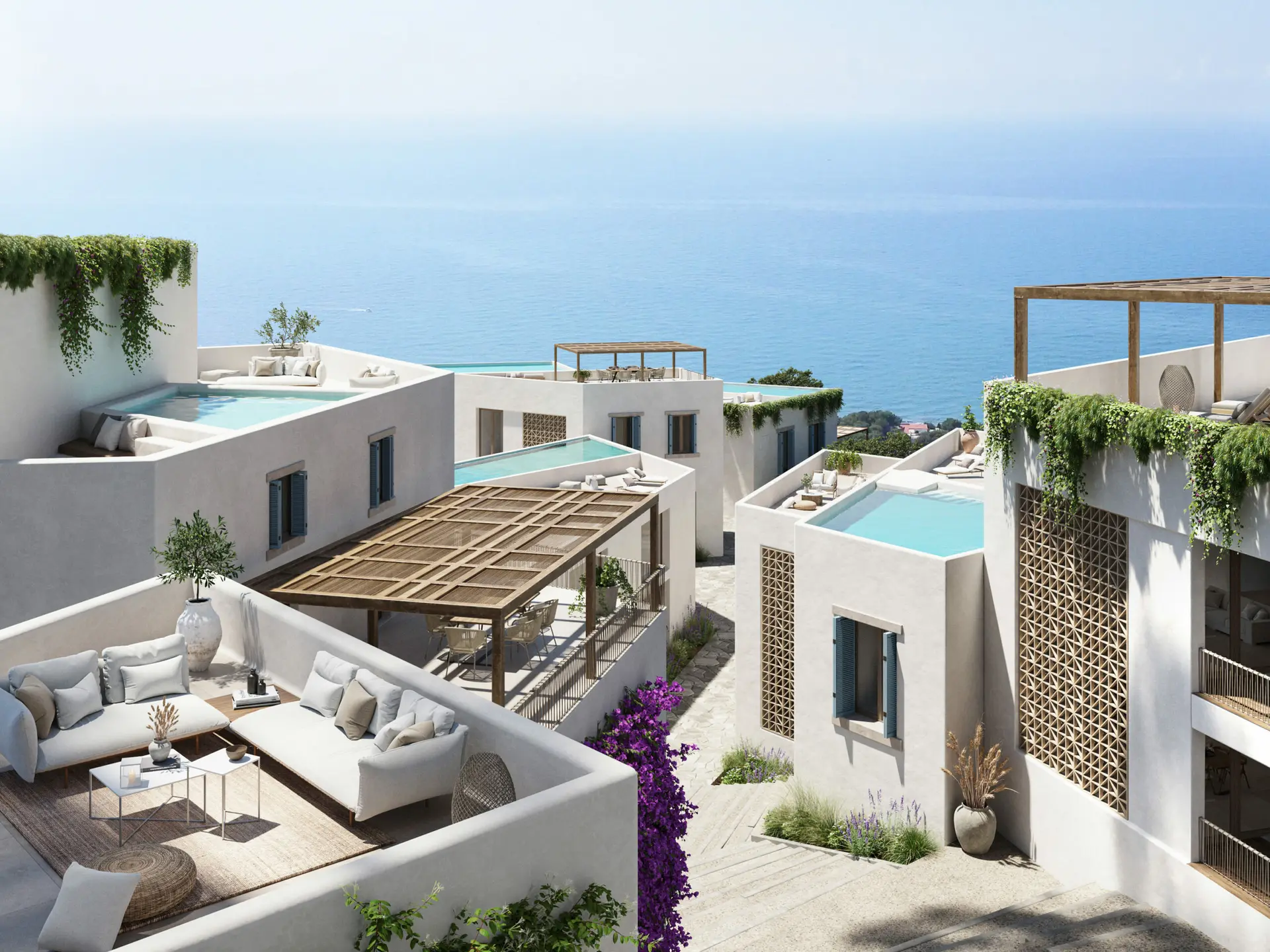 Oversigtsbillede af landsbyen i Porta de Mar over kysten, med terrasserne og poolene ud mod havet