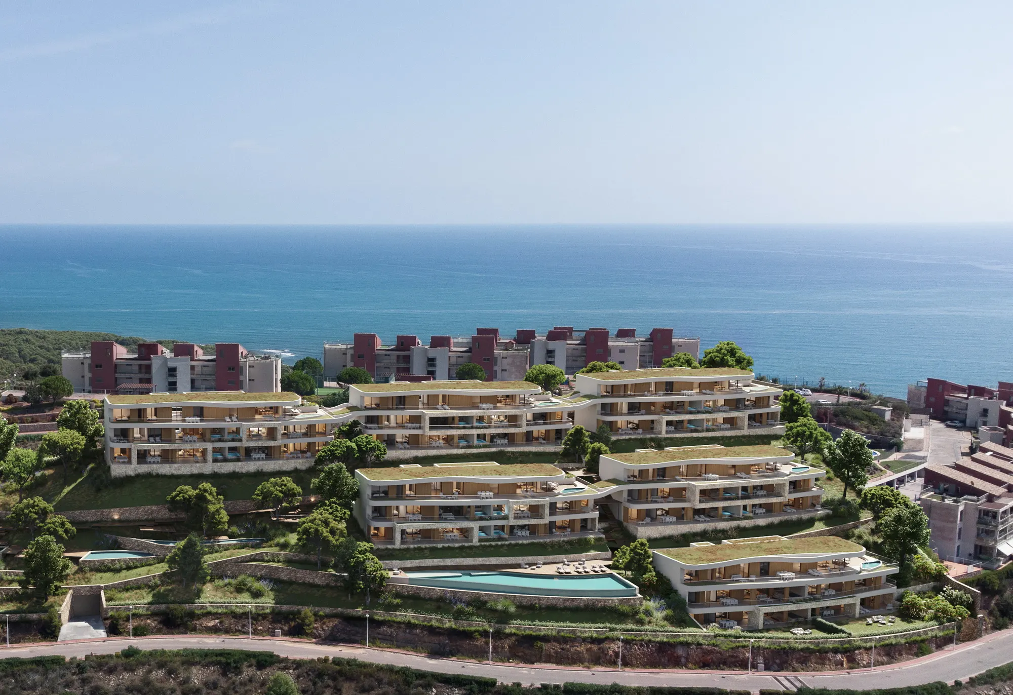Vista aérea de los seis bloques de Barlovento escalonados en la ladera de La Colomera, con el Mediterráneo al fondo