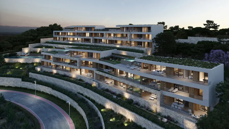 Rendering af Andryala i skumringen, med de trappede bygninger oplyst på skråningen